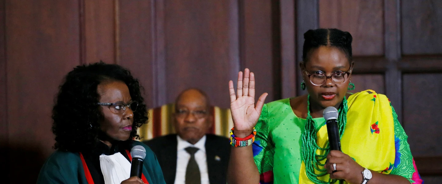 South Africa's President Jacob Zuma (back) looks on as Constitutional Court judge Sisi Khampepe (left) administers the swearing-in of Minister of Energy Mmamoloko Kubayi during a ceremony at Presidential Guest House in Pretoria, March 31, 2017. Kubayi has served as South Africa's minister of justice since December 2024. Photo by Phill MAGAKOE/AFP.