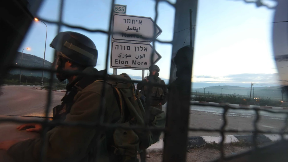 Israeli soldiers block a road near Huwara, south of the Samaria city of Nablus (Shechem), March 12, 2011. Photo by Nati Shohat/Flash90.