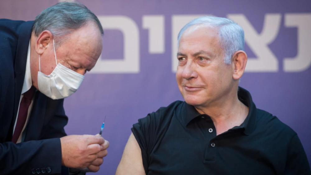 Israeli Prime Minister Benjamin Netanyahu receives the second dose of Pfizer's COVID-19 vaccine at the Sheba Medical Center at Tel HaShomer outside of Tel Aviv on Jan. 9, 2021. Photo by Miriam Alster/Flash90.