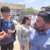 Almog Cohen, right, speaks with protesters demonstrating against Yair Golan at a conference in Be'er Sheva, Israel on may 27, 025. Photo by Canaan Lidor.