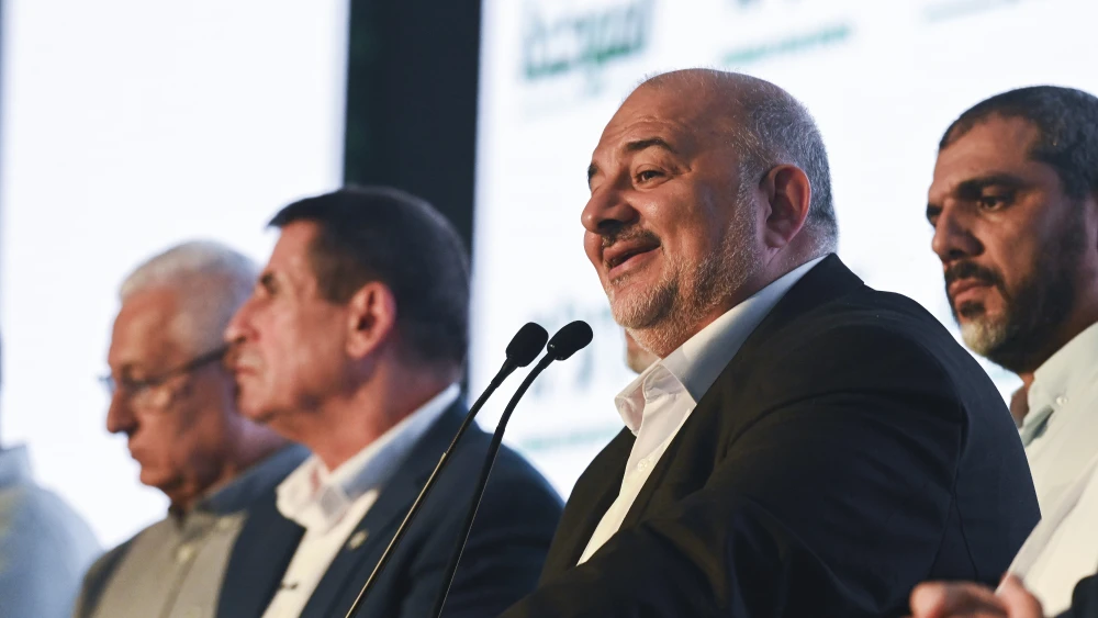 United Arab List (Ra’am) party chairman Mansour Abbas stands alongside fellow party members on stage following the release of exit poll results in the northern Israeli city of Sakhnin, on Israel’s general election night, Oct. 27, 2026. Photo by Michael Giladi/Flash90.