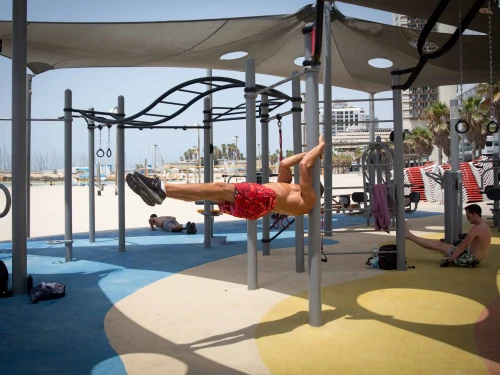 Israelis exercise at an outdoor gym at the beach in Tel Aviv on a hot summer day, July 28, 2020. Photo by Miriam Alster/Flash90.