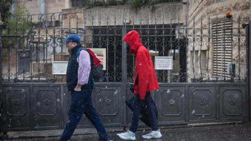 People walk in the rain in Jerusalem, on Nov. 25, 2025. Photo by Yonatan Sindel/Flash90.