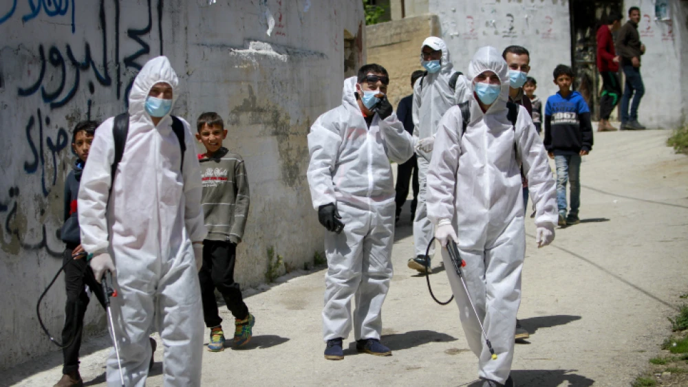Palestinian workers clear streets and homes in the West Bank city of Nablus on April 3, 2020, enabling measures to prevent the spread of COVID-19. Photo by Nasser Ishtayeh/Flash90.
