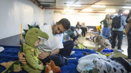 Israelis take cover from incoming missiles at an undergoing parking lot in Tel Aviv, March 3, 2026. Photo by Chaim Goldberg/Flash90.