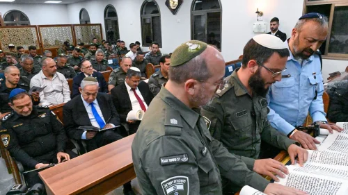 Israeli Prime Minister Benjamin Netanyahu and National Security Minister Itamar Ben-Gvir (both seated) attend a Scroll of Esther reading for Purim at a synagogue at the Beit Horon Border Police base, March 6, 2023. Photo by Kobi Gideon/GPO.