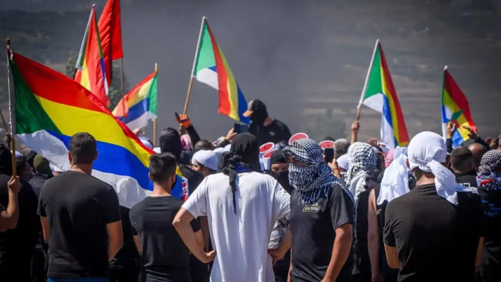 Druze protest while police guard during a protest against the construction of a new wind farm in the Druze village of Mas'ada, in the Golan Heights, June 21, 2023. Photo by Ayal Margolin/Flash90 *** Local Caption *** ???? ???????? ????? ?????? ??????? ????? ???? ??