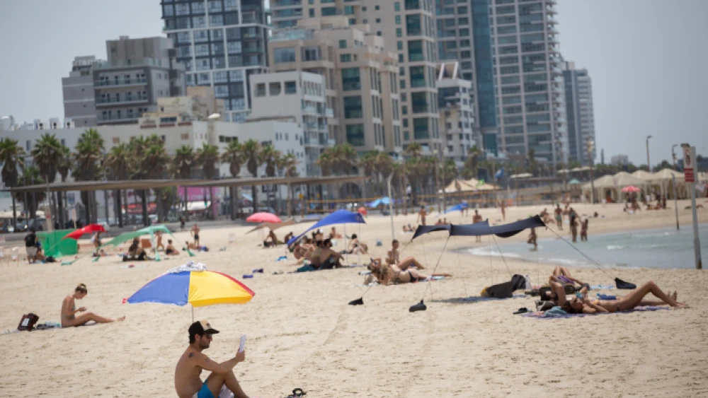 Israelis enjoy the beach on a hot summer day in Tel Aviv on July 28, 2020. Photo by Miriam Alster/Flash90.