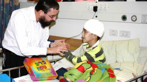 Rabbi Menachem Kutner, director of the Chabad Terror Victims Project, brings a gift to Ural Yelizarov, who was wounded in the head by a Grad rocket in Beersheva during “Operation Cast Lead” in 2014. Credit: CTVP.