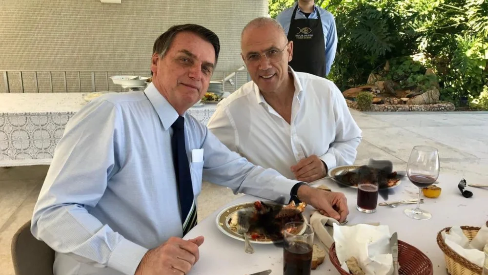 Israel’s Ambassador to Brazil Yossi Shelley dining with Brazilian President Jair Bolsonaro. The picture features a poorly doctored covering up (with black X marks) of the two men eating lobsters, which is forbidden under Jewish dietary law and sparked a minor controversy in Israel. Credit: Twitter.
