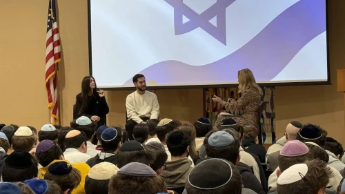 Former Israeli hostage Eliya Cohen, held by Hamas in Gaza, and his fiancée, Ziv Amud, speak to students at The Frisch School in New Jersey. Credit: Courtesy.
