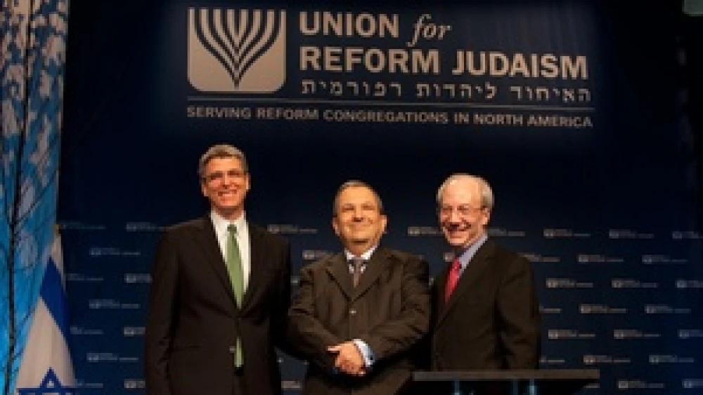 New Union for Reform Judaism President Rabbi Rick Jacobs (far left) and outgoing URJ President Rabbi Eric Yoffie flank former Israeli Prime Minister Ehud Barak at the URJ biennial convention in Washington, D.C. Credit: Courtesy Union for Reform Judaism.