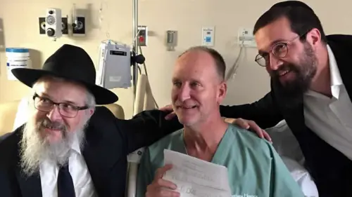 Officer Dan Mead, center, holds a letter of thanks from second-grade students at Yeshiva Schools of Pittsburgh. He is flanked by Rabbi Yisroel Rosenfeld, left, and Rabbi Henoch Rosenfeld. Credit: Chabad.org/News.