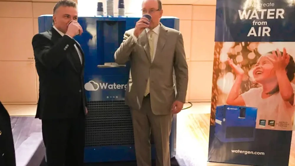 Monaco's Prince Albert II and Dr. Michael Mirilashvili drinking from Watergen's system. Credit: Watergen.