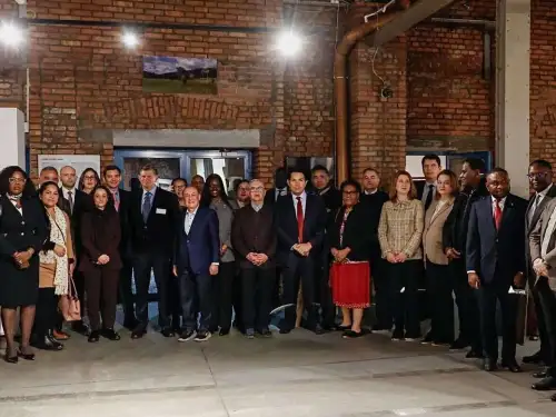 Danny Danon, waering a red tie and standing left of the woman in red, leads U.N. ambassadors at Oskar Schildner's former factory in Krakow, Poland on Feb. 18, 2026. Photo courtesy of Danon's office.
