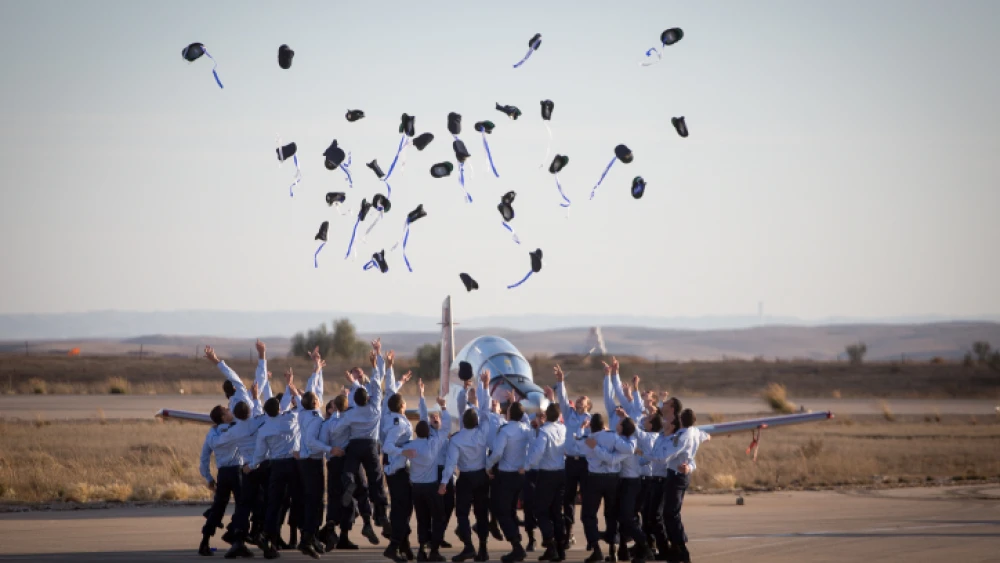 Air Force pilots throw their hats in the air in celebration at a graduation ceremony for soldiers who have completed the official IAF flight course (Hatzerim Air Base, Negev Desert), Dec. 29, 2016. Photo by Miriam Alster/Flash90.