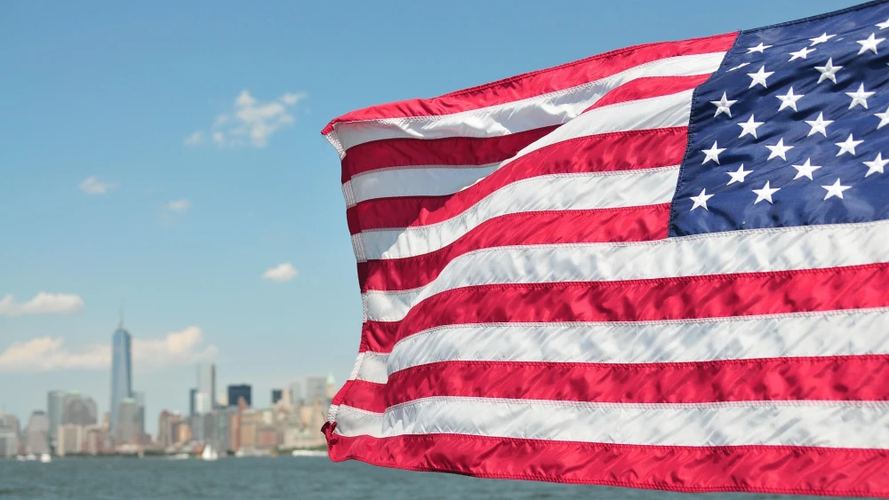 American flag with Manhattan in the background. Credit: tammo/Pixabay.
