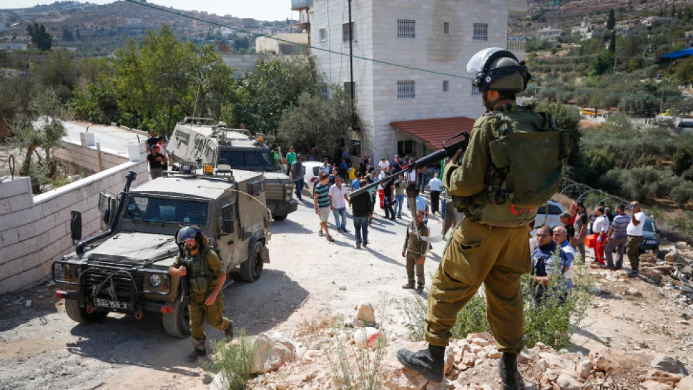Palestinians clash with Israeli security forces as Israeli bulldozer demolishes a Palestinian house in the village of Walajeh, near Bethlehem on Sept. 3, 2018. Photo by Wisam Hashlamoun/Flash90.
