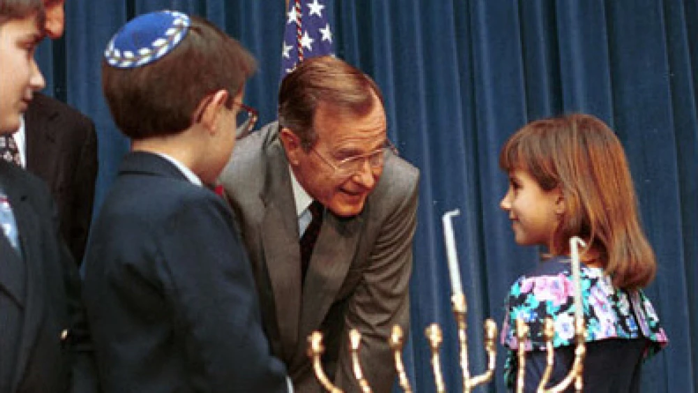 President George H. W. Bush speaks with children at 1991 White House Staff Hanukkah menorah-lighting. Credit: Archives and Records Administration.