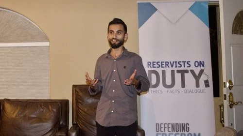 A representative of Reservists on Duty (RoD) speaks Monday night at Stanford Chabad as part of a program highlighting the stories of Israeli minorities. After the Stanford Israel Association and Stanford Hillel withdrew from the RoD event, Chabad agreed to host it. Credit: Stanford Chabad.