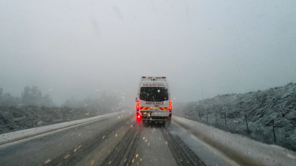 An ambulance drives through the snow in the Golan Heights, Jan. 19, 2022. Photo by Michael Giladi/Flash90.