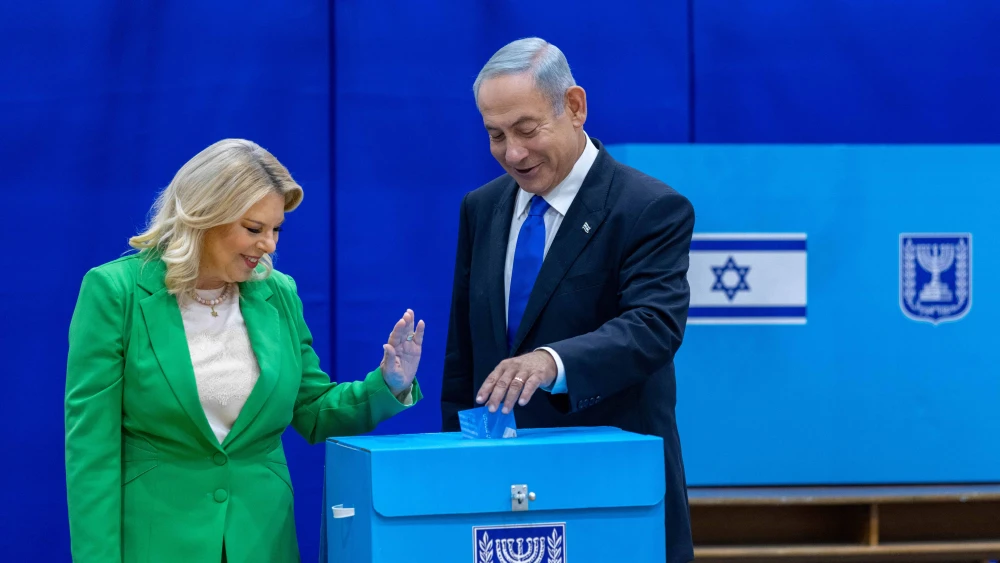 Likud Chairman Benjamin Netanyahu casts his ballot at a voting station in Jerusalem alongside his wife, Sara, on Nov. 1, 2022. Photo by Olivier FitoussiFlash90.