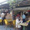 Israeli Jews and Palestinian Arabs eat lunch at a falafel joint in an Arab strip mall in Ariel Credit: Orit Arfa.