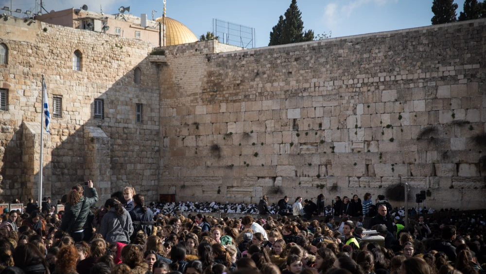 Members of the Women of the Wall movement hold Rosh Chodesh prayers as thousands of ultra-Orthodox women protest against them at the Western Wall in Jerusalem's Old City on March 8, 2019. Credit: Hadas Parush/Flash90.