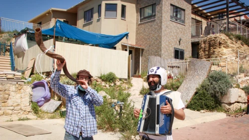 Israelis play musical instruments in the streets of the Jewish town of Bat Ayin to entertain the residents during the Passover holiday as the country remains on lockdown due to the coronavirus pandemic, April 13, 2020. Photo by Gershon Elinson/Flash90.