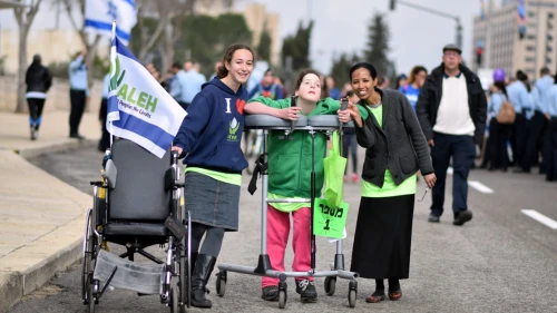 Volunteers and their young charge at a march for ALEH, Israel’s network of care for children with severe complex disabilities. Credit: Courtesy.