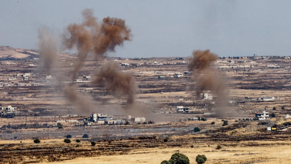 A picture taken from the Israeli side depicts smoke rising near the Israeli-Syrian border in the Golan Heights during fights between the rebels and the Syrian army, June 25, 2017. Photo by Basel Awidat/Flash90.