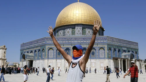 A Palestinian rioter raises his hands in a "V" for "victory" near the Dome of the Rock on the Temple Mount in Jerusalem. Photo by Sliman Khader/Flash90.