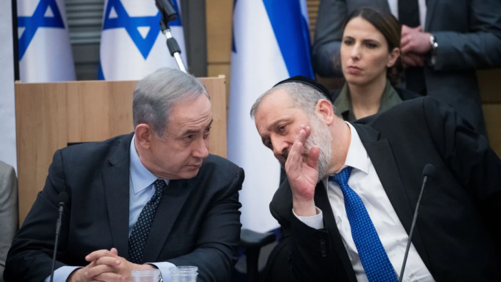 Israeli Prime Minister Benjamin Netanyahu speaks with Shas Party chairman Aryeh Deri during a meeting with the heads of the right-wing parties on March 4, 2020. Photo by Yonatan Sindel/Flash90.