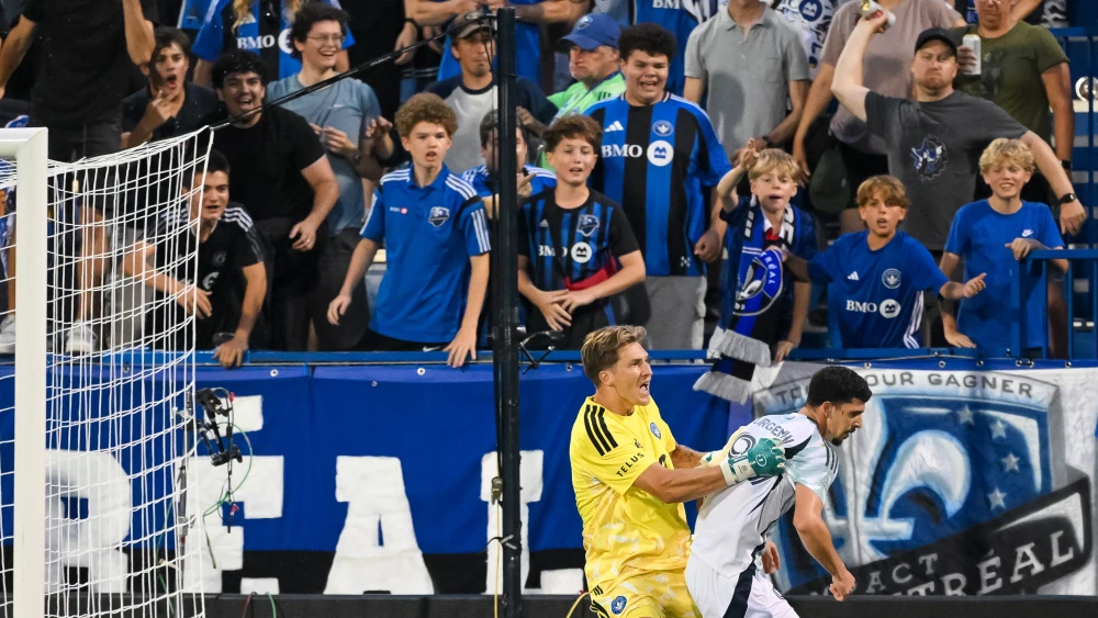 CF Montréal goalkeeper Sébastian Breza (left) pushes New England Revolution forward Dor Turgeman after he celebrated a goal in front of home fans during the first half at Saputo Stadium in Montreal, Aug. 1, 2026. Photo by Tim Austen/Getty Images.