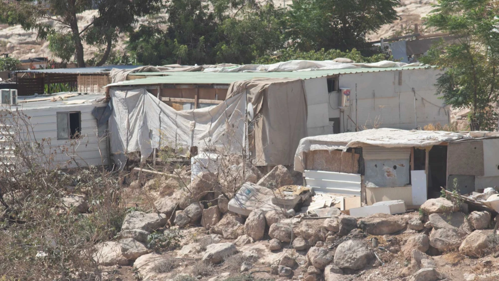 A ramshackle Bedouin home of corrugated metal near the entrance to Ma'ale Adumim, Aug. 18, 2025. Photo by David Isaac.