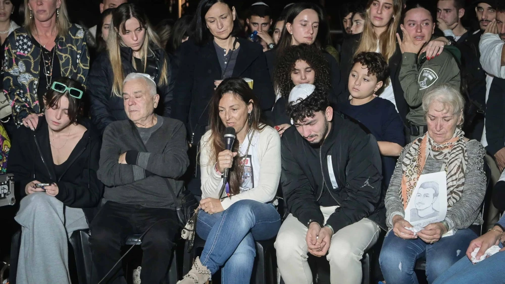 Ayelet Samerano, speaking into a microphone, eulogizes her son Yonatan in Tel Aviv, December 4, 2023. Photo by Avshalom Sassoni/Flash90.