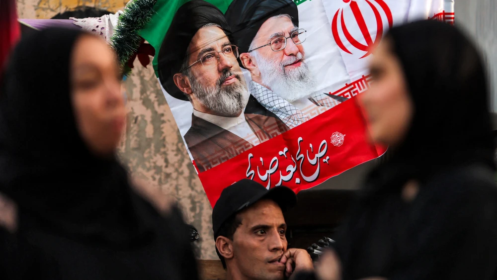 An Iranian flag bearing depictions of Iranian Supreme Leader Mojtaba Khamenei and his slain father and predecessor, Ali Khamenei, is displayed during a Shiite Muslim procession ahead of the Muharram season of mourning in Baghdad, June 21, 2026. Photo by Ahmad Al-Rubaye/AFP via Getty Images.
