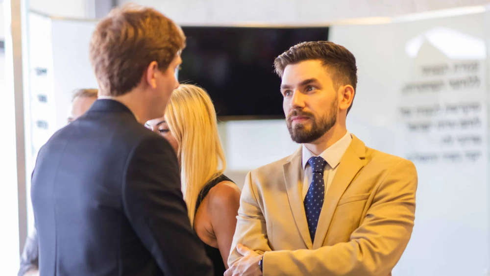 Holocaust historian László Bernát Veszprémy speaks with a participant of The October Effect conference in Jerusalem on Sept. 9, 2024. Photo by Daniel Stravo/IDSF.