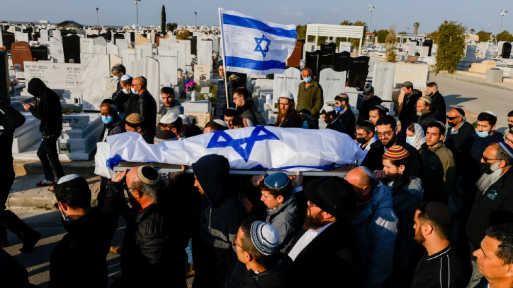 Mourners carry the body of 67-year-old Menahem Yehezkel, who was stabbed to death by a Bedouin Arab during a car-ramming attack in the southern Israeli city of Beersheva on March 22, during his funeral at a Beersheva cemetery on March 23, 2022. Photo by Olivier Fitoussi/Flash90.