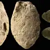 A butterfly clay bead from the Final Natufian period in Eynan-Mallaha (Upper Jordan Valley), colored red with ochre and marked with the fingerprints of the child (≈10 years old) who modeled it 12,000 years ago. Credit: Laurent Davin