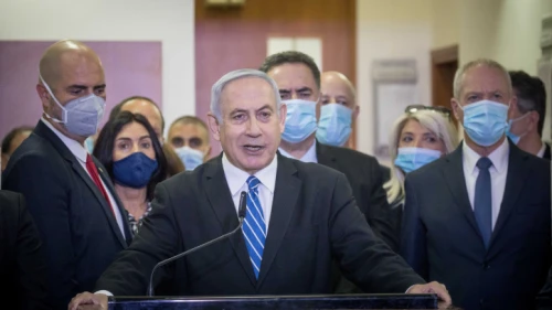 Israeli Prime Minister Benjamin Netanyahu is surrounded by Likud lawmakers as he gives a press statement ahead of the start of his trial at the District Court in Jerusalem, May 24, 2020. Photo by Yonatan Sindel/Flash90.