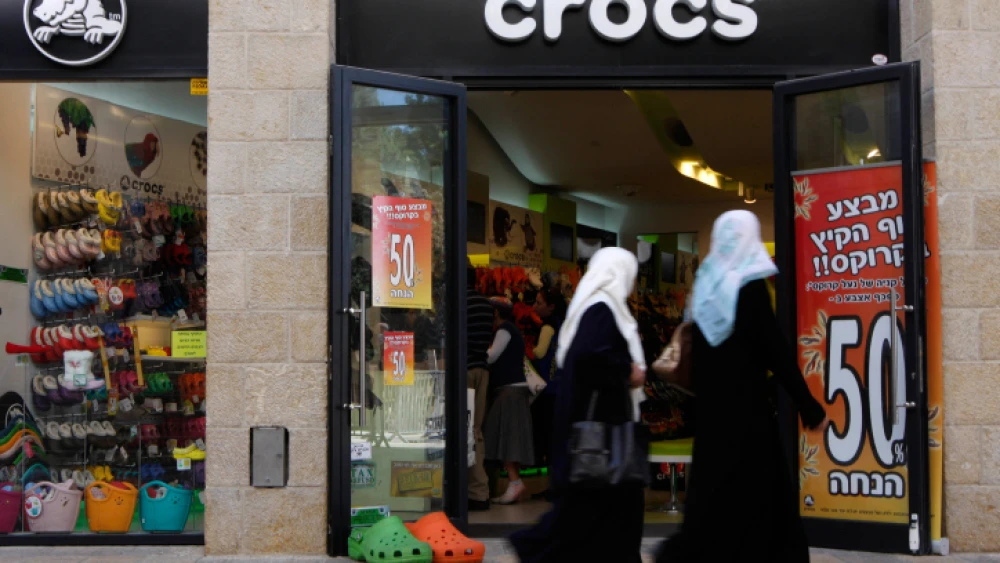 Arab women walk by a shoe store selling Crocs at the Mamila Mall in Jerusalem on Sept. 22, 2009. Photo by Miriam Alster/Flash90.