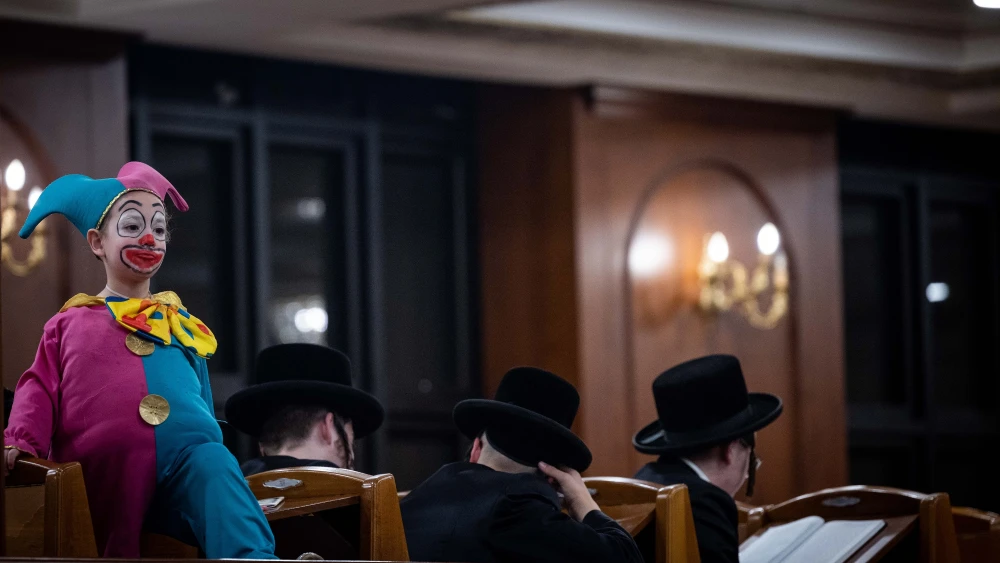 Orthodox Jewish men and children read the Megillat Esther (Scroll of Esther) on the eve of the Jewish holiday of Purim inside Yeshiva Belz (Chassidic dynasty) in Jerusalem on March 7, 2023. Photo by Yonatan Sindel/Flash90.