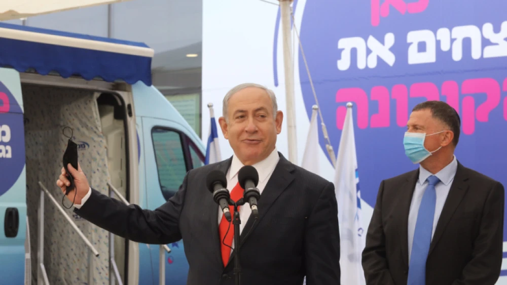 Israeli Prime Minister Benjamin Netanyahu and Health Minister Yuli Edelstein attend a press conference at a Maccabi health fund vaccine center in Tel Aviv on Dec. 13, 2020. Photo by Marc Israel Sellem/POOL.