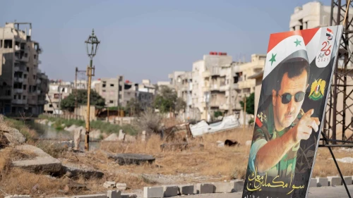 A poster of President Bashar Assad in Homs's destroyed city center during the Syrian civil war, Aug. 25, 2021. Photo by Lena Ha/Shutterstock.