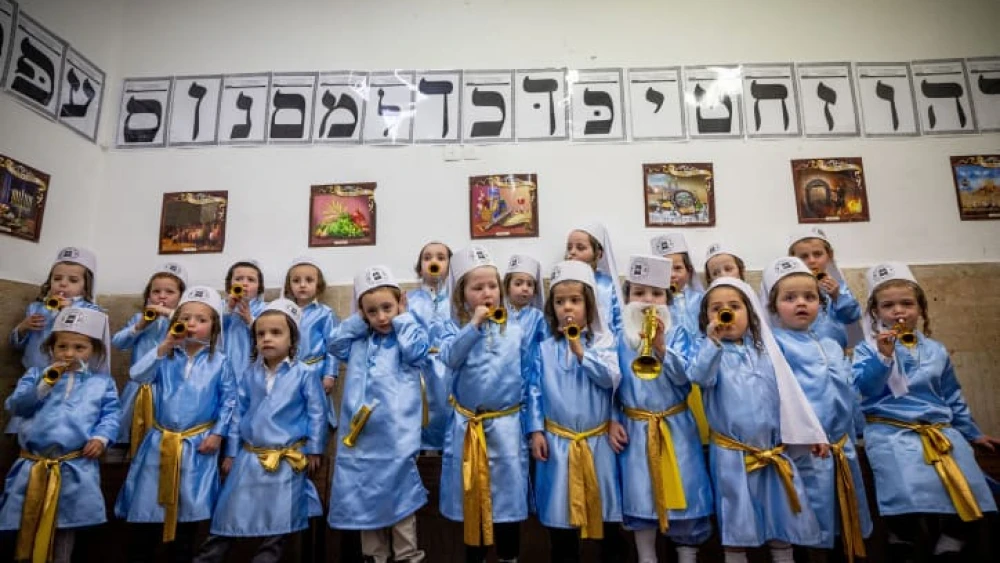 Jewish children from Pinsk-Karlin Chassidic group dressed up in costumes at their school in Jerusalem's ultra-Orthodox Mea Shearim neighborhood a few days before Purim, March 5, 2022. Photo by Yonatan Sindel/Flash90.