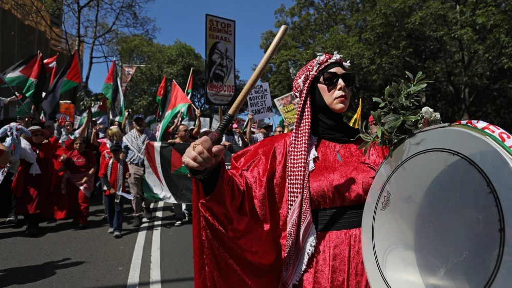 Pro-Palestine activists march through the central business district (CBD) on Oct. 11, 2026 in Sydney, Australia. People gathered in Sydney on Oct. 11 in solidarity with Palestinians in Gaza as part of a "global day of action." Photo by Lisa Maree Williams/Getty Images.