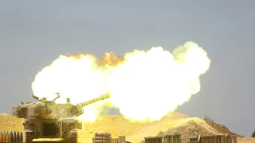 An IDF tank fires into the Gaza Strip near the border following multiple days of heavy rocket and missile barrages launched into Israel by terror factions in Gaza, May 12, 2021. Photo by Yonatan Sindel/Flash90.