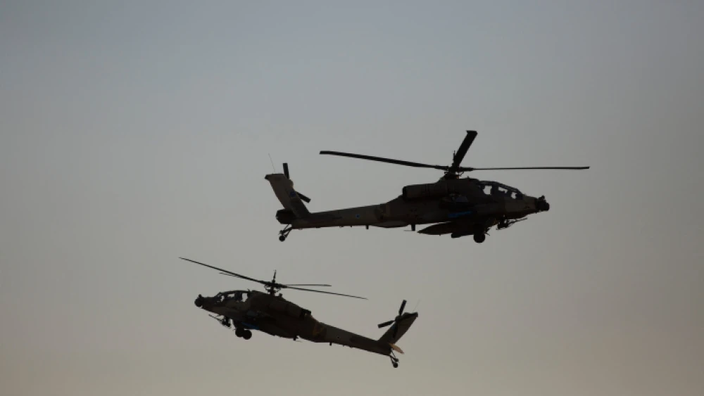 Israeli AH-64 Apache Longbow helicopters take part in an air show for a graduation ceremony at the Hatzerim base in the Negev Desert, near the southern Israeli city of Beersheva, on Dec. 31, 2015. Photo by Lior Mizrahi/Flash90.