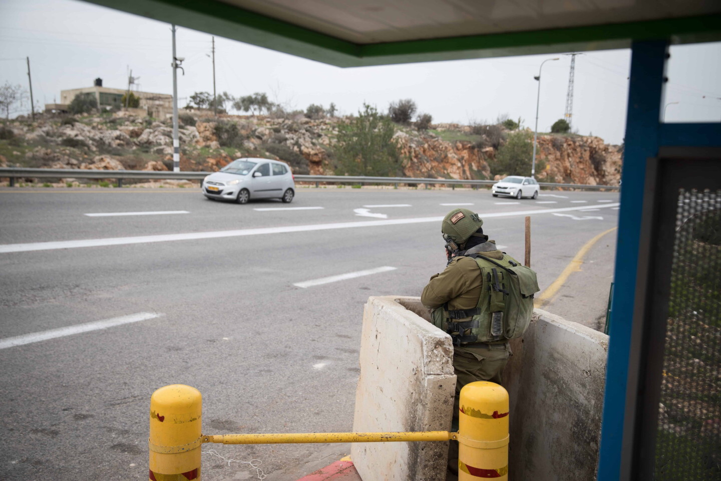 Israeli soldiers guard a bus stop on Route 60 near the entrance to the Israeli community of Ofra in Samaria, Dec. 16, 2018. Photo by Hadas Parush/Flash90.
